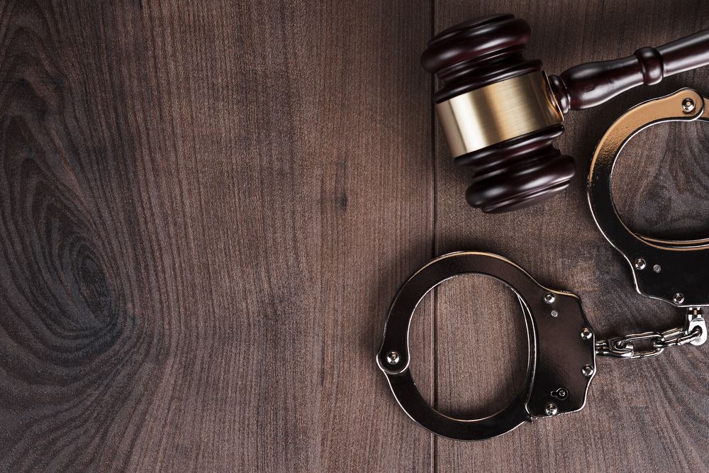 gavel and handcuffs on table